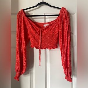 Urban outfitters cropped long sleeve orange/ red pattern top